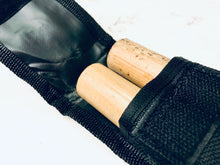 Load image into Gallery viewer, Rattan stick ends tucked into the Complete Starter Kit's black nylon carrying case
